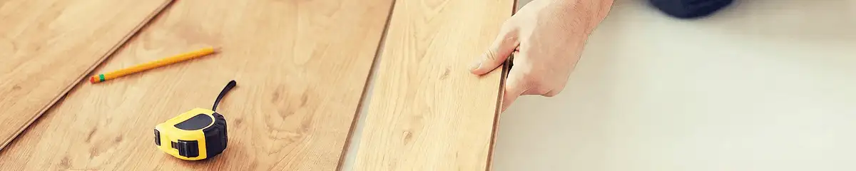 A professional installing wood flooring in West Palm Beach, FL