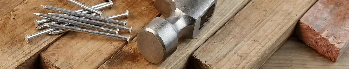 Hammer and nails on hardwood flooring boards in West Palm Beach, FL