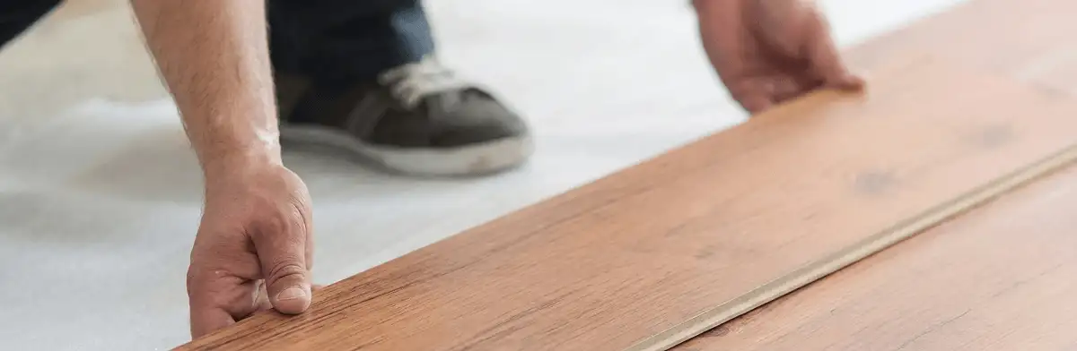 A professional installing laminate flooring in West Palm Beach, FL