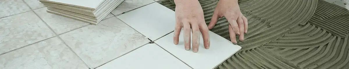 Professional installing white tile floors in West Palm Beach, FL